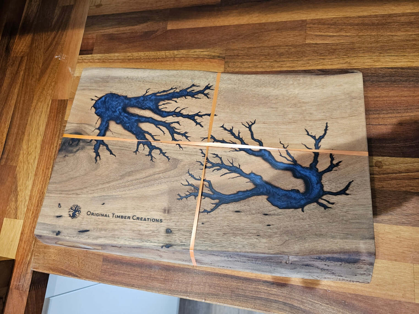 Handcrafted Resin Inlaid Wooden Board showcasing intricate blue resin inlays and natural wood grain detail.