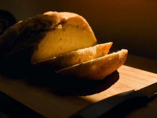 Sliced loaf of bread on a wooden cutting board