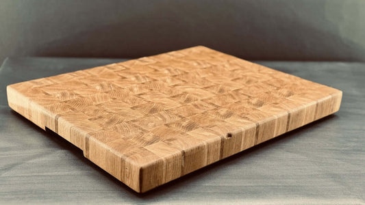 A wooden end-grain cutting board sits still.