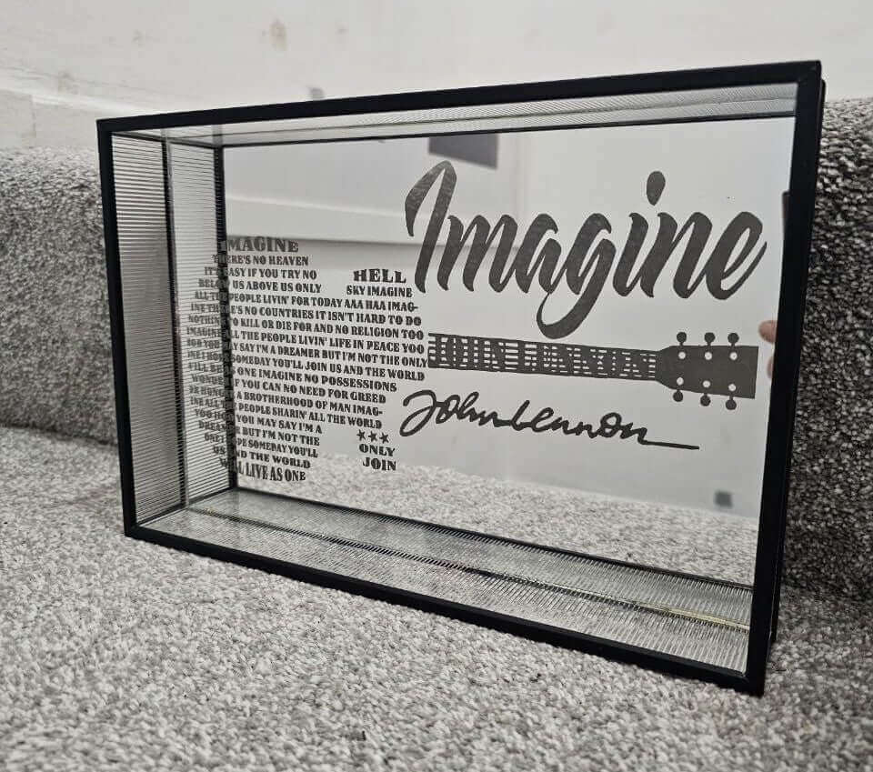 The Art of Laser Engraved Mirrors featuring a reflective piece with lyrics from Imagine by John Lennon.