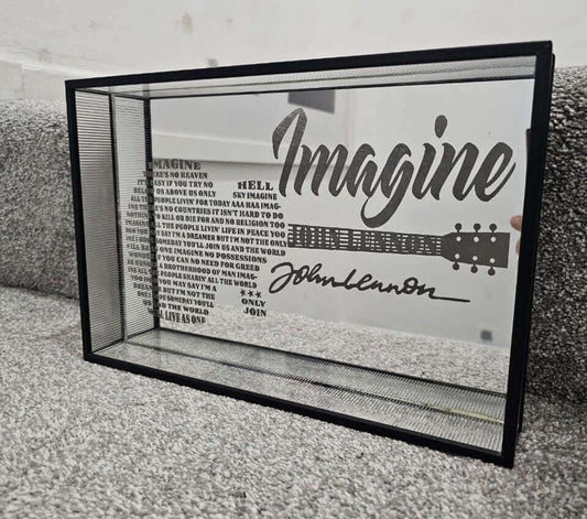 The Art of Laser Engraved Mirrors featuring a reflective piece with lyrics from Imagine by John Lennon.