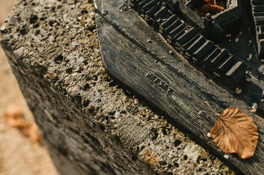 a wooden bench with a leaf on it