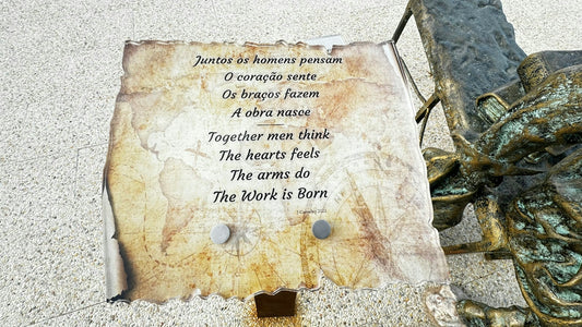a bronze statue with a poem written on it
