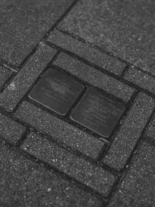 Two brass plaques set in cobblestones