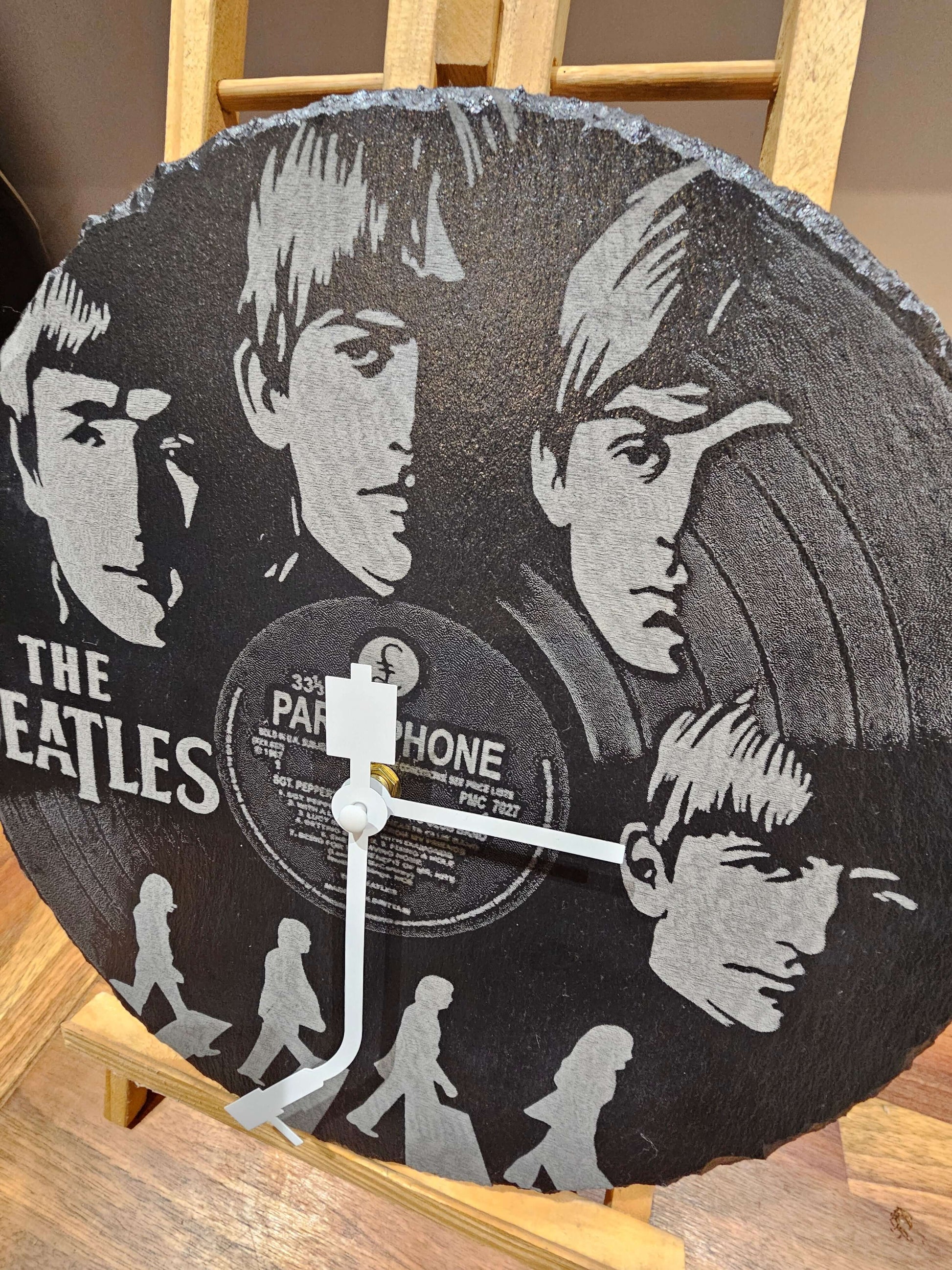 The Beatles Engraved Slate Clock 30cm Round Handmade UK Gift showcasing laser-engraved portraits and vinyl record design.