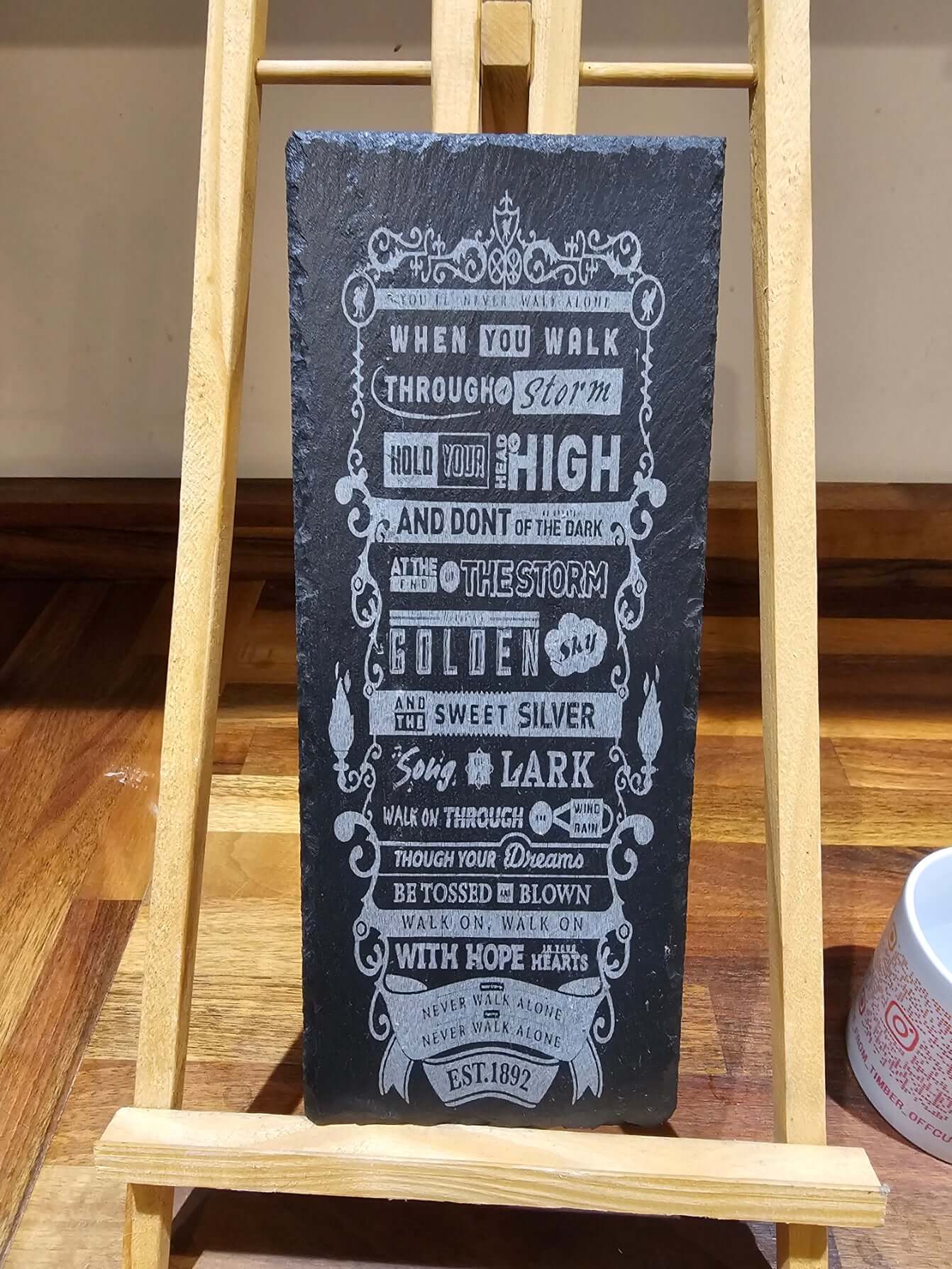 engraved slate plaque you'll never walk alone on display with inspirational lyrics and design