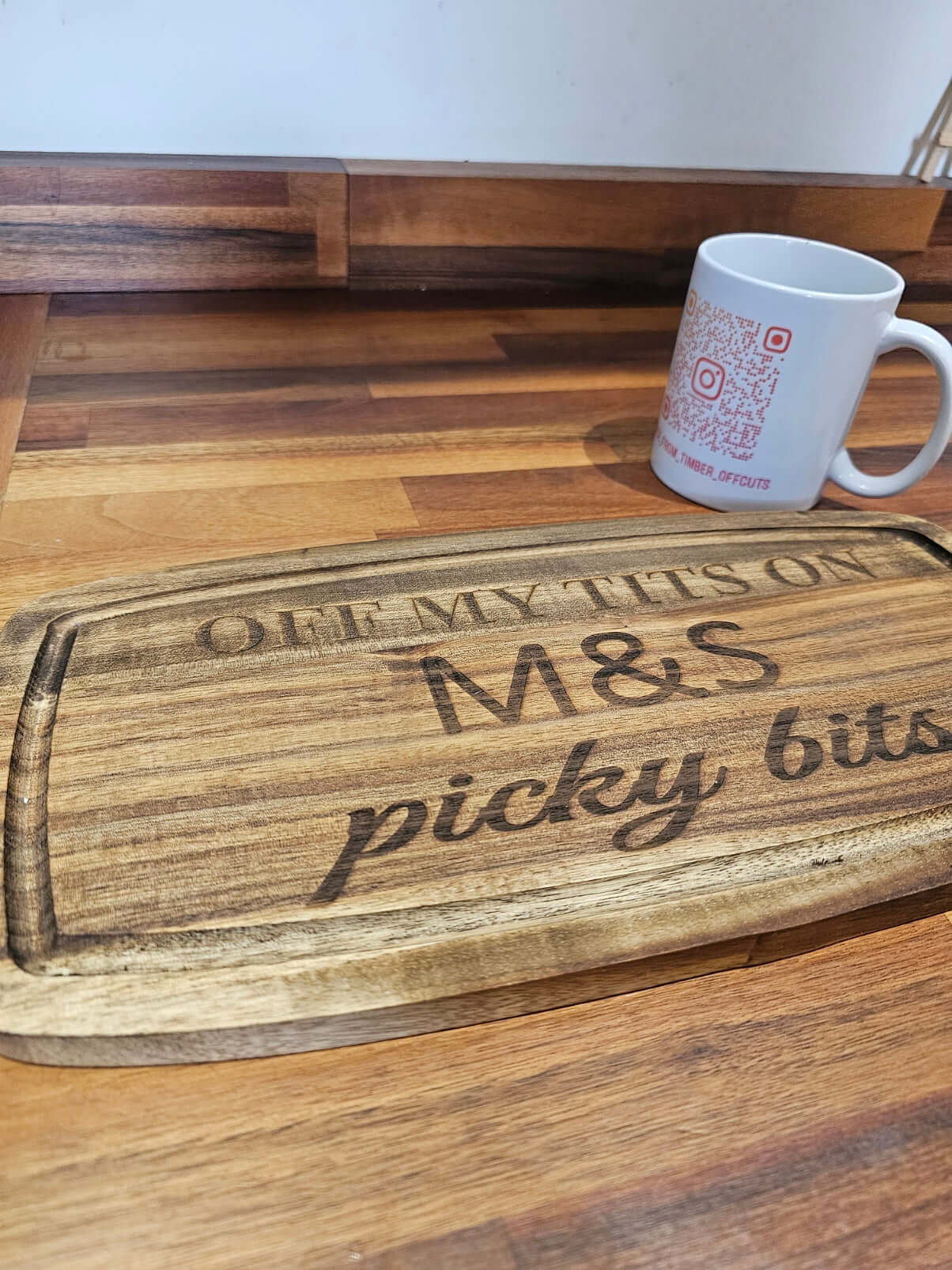 Funny Engraved Wooden Serving Tray with humorous text 'Off My Tits on M&S Picky Bits' against a wooden background.