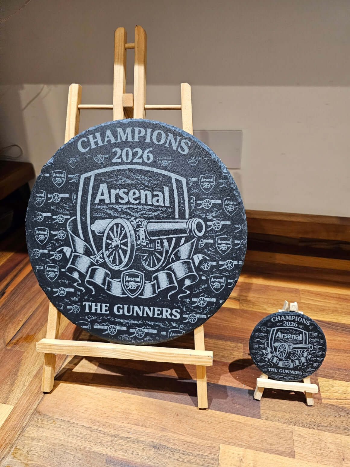 Arsenal Champions 2026 Engraved 300mm Round Slate Plaque Memorabilia displayed on an easel.