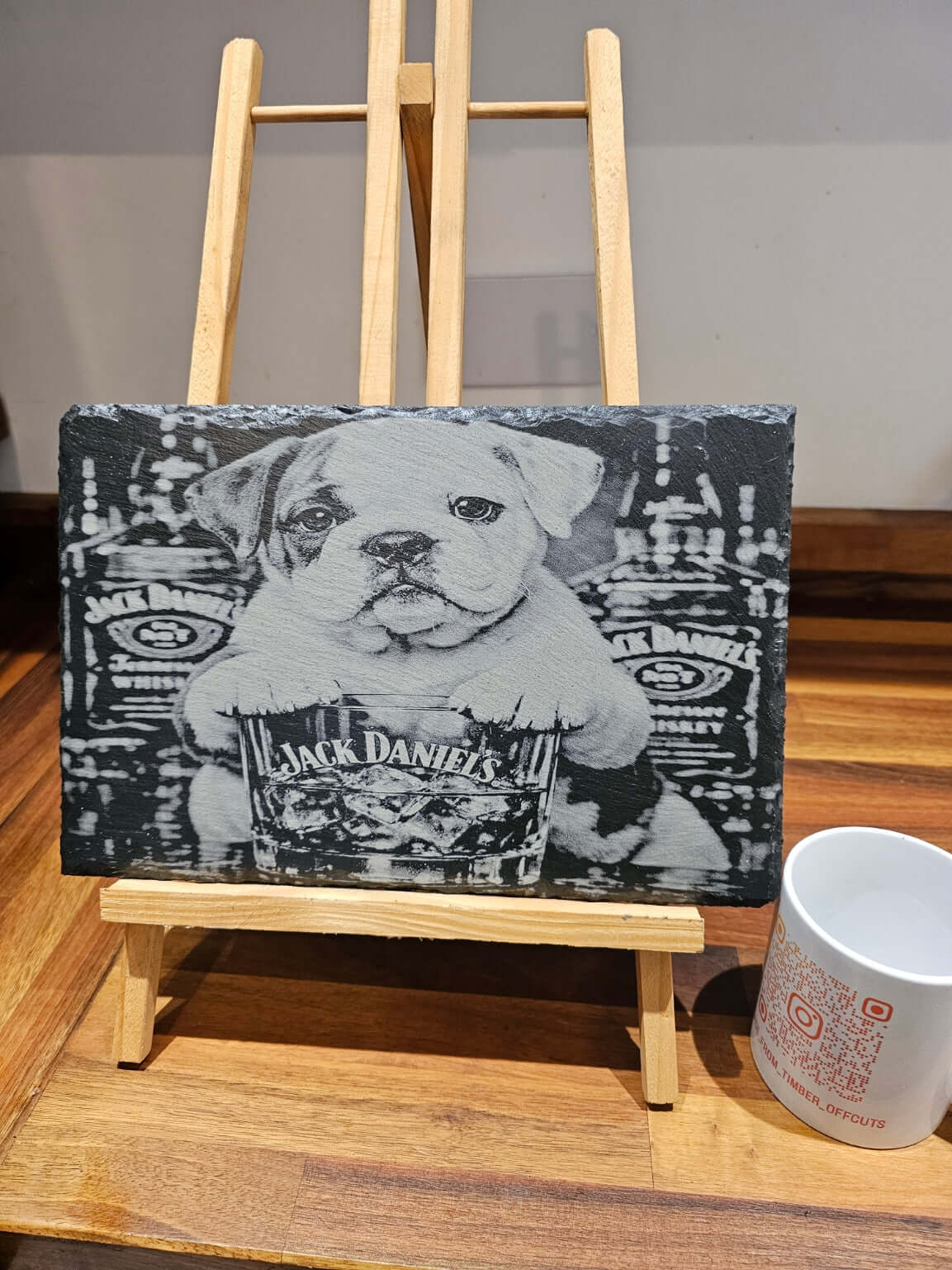 Funny Bulldog Jack Daniels Slate Plaque displayed on an easel, showcasing a bulldog with Jack Daniels whiskey.