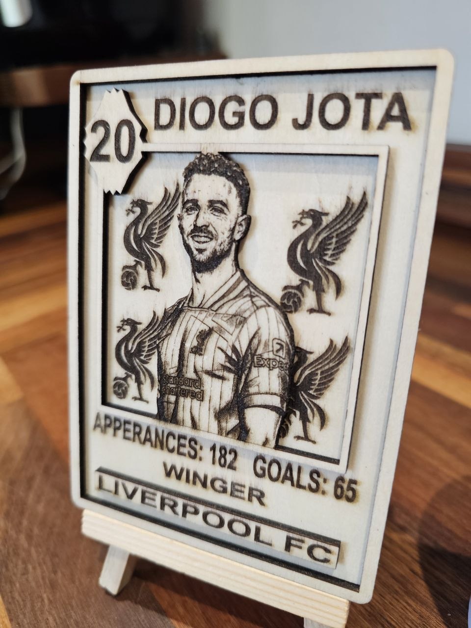 Custom wooden sports card Diogo Jota with statistics and Liverpool FC logo in engraved design.