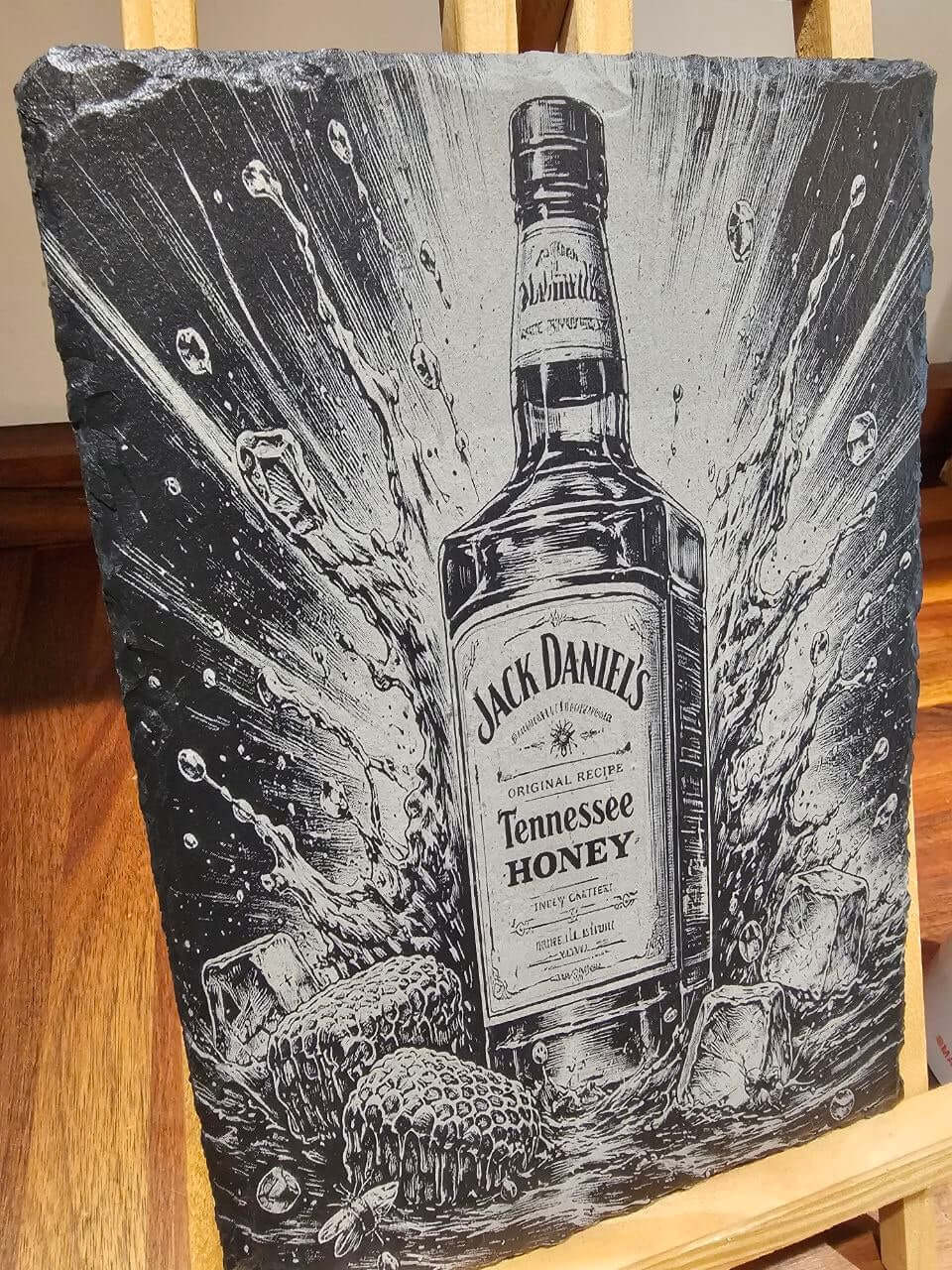 Slate Plaque Whiskey Bottle featuring an engraved Jack Daniel's Tennessee Honey design with splash effects.