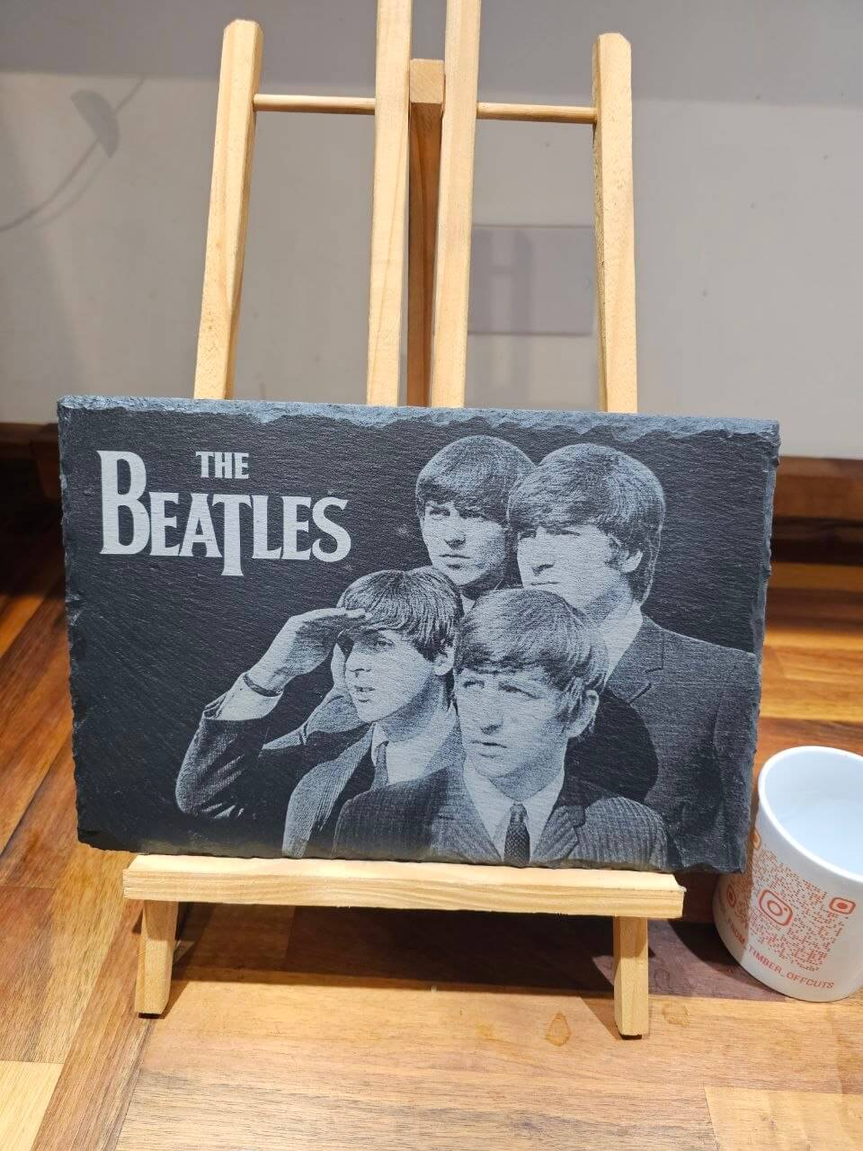 Slate plaque featuring The Beatles portrait, showcasing their iconic engraved artwork, perfect for music lovers.