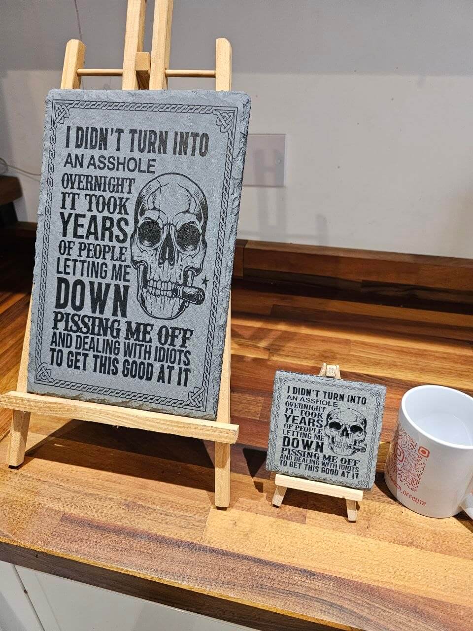 I Didn’t Turn Into an Asshole Overnight slate plaque. 30x20cm displayed on an easel with a smaller version.