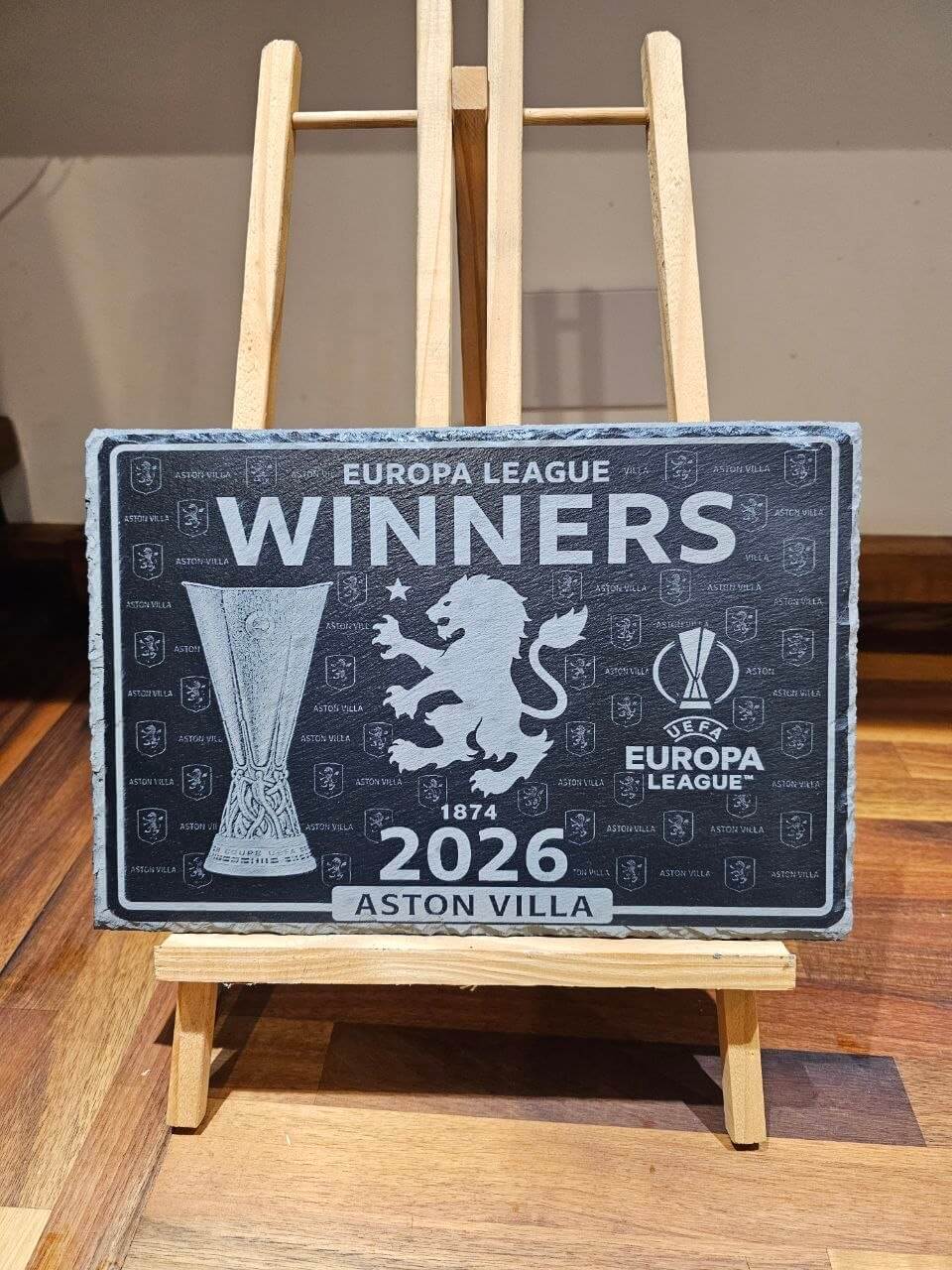 Aston Villa Europa League Winners 2026 Slate Plaque displayed on an easel, celebrating the team's achievement.