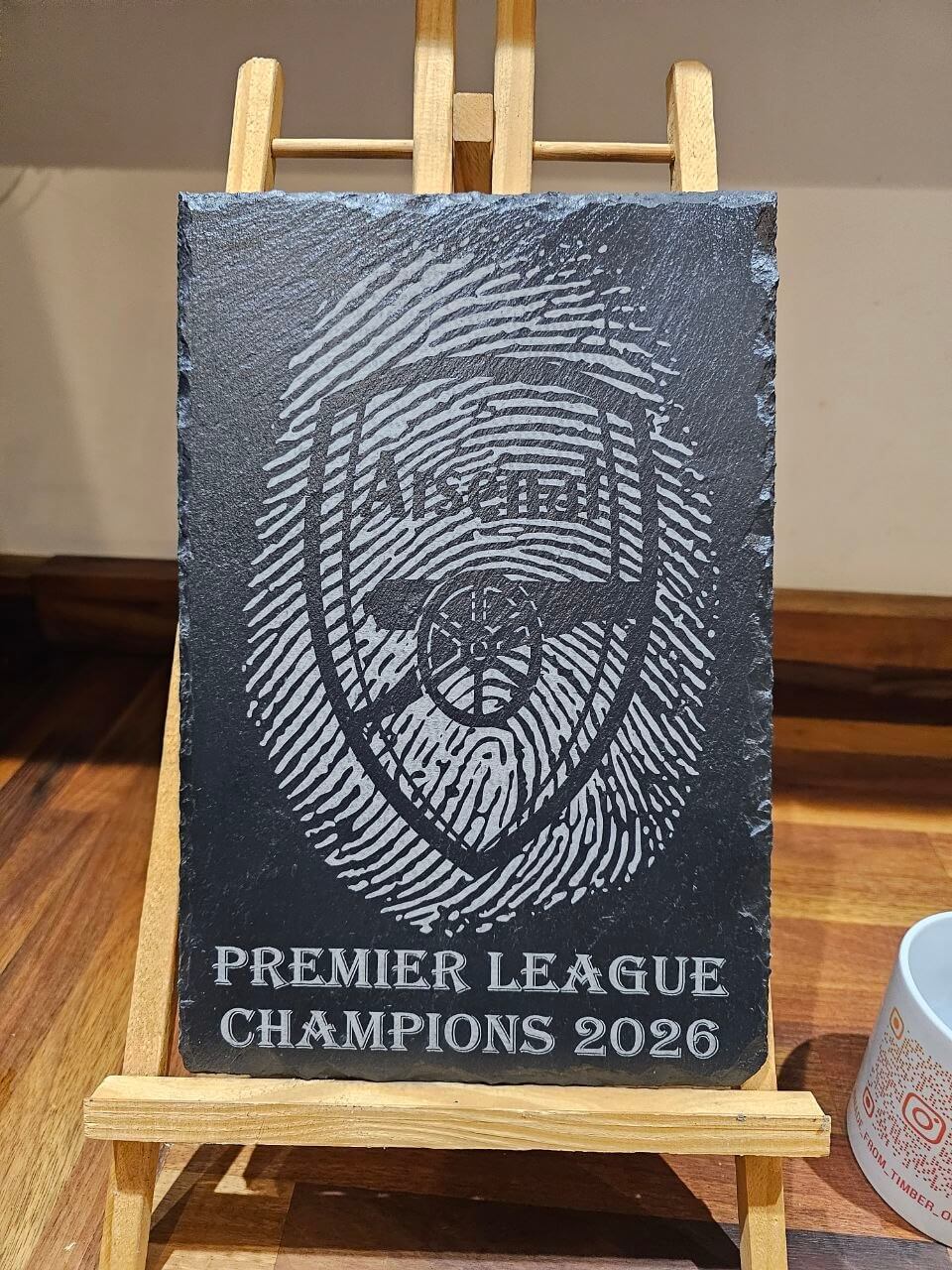 Arsenal Premier League Champions 2026 Fingerprint Plaque displayed on an easel with the Arsenal crest.